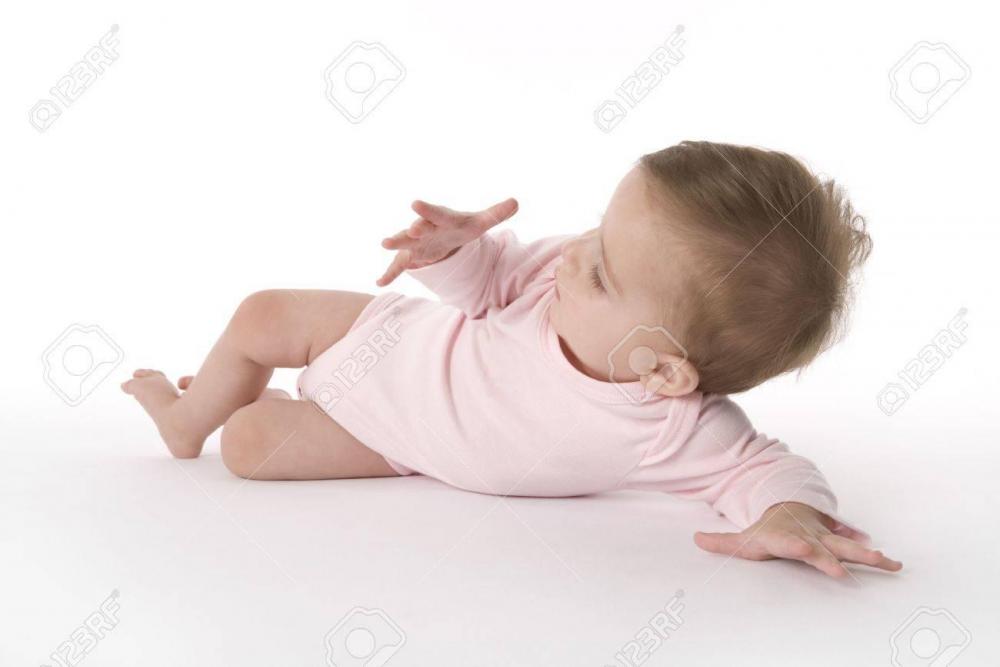 5434164-baby-girl-lying-on-the-floor-looking-at-her-own-hand.jpg
