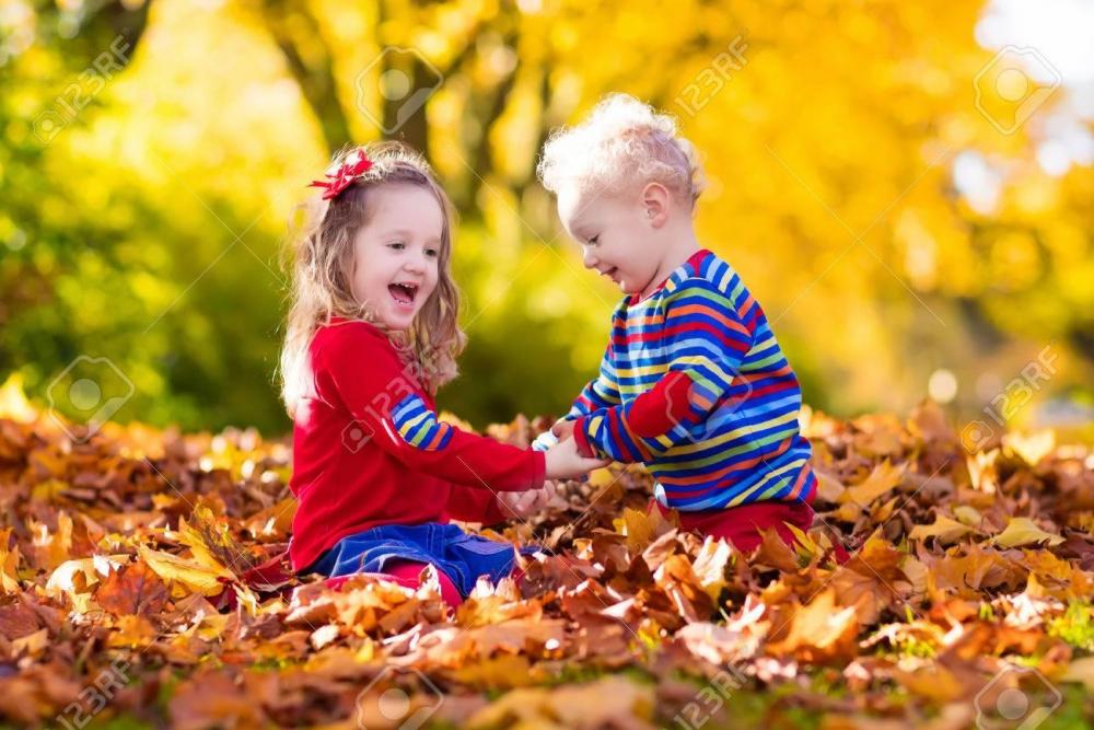 61813204-happy-children-playing-in-beautiful-autumn-park-on-warm-sunny-fall-day-kids-play-with-golden-maple-l.jpg