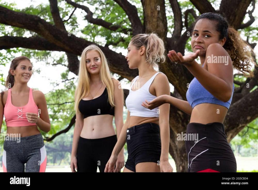 black-african-american-woman-feel-boring-in-talking-with-young-multiethnic-women-friends-group-on-yoga-exercise-class-in-the-park-at-weekend-morning-2G5CB34.jpg