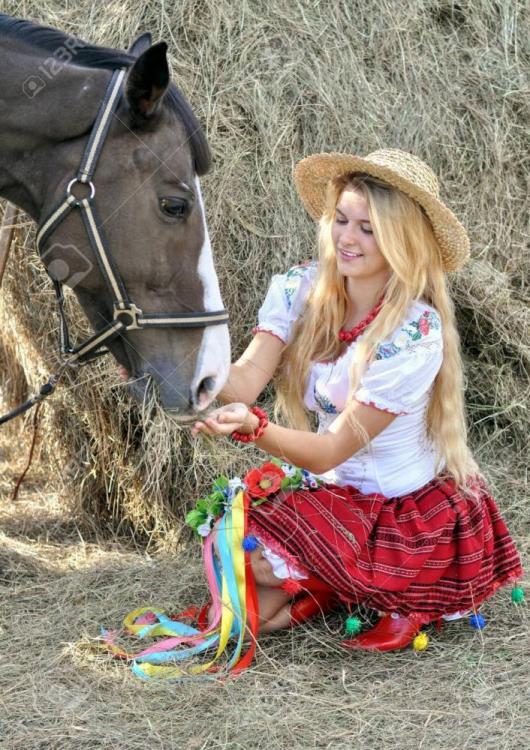 69862052-ukrainian-teenage-girl-in-traditional-clothes-feeds-horse-in-the-farm.jpg