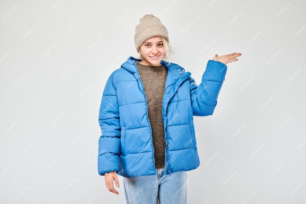 young-woman-blue-winter-jacket-holding-something-hand-demonstrating-empty-space-product-text-isolated-white-studio-background_154092-30521-3020998255.jpg