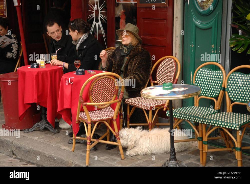woman-smoking-a-cigarette-outside-a-cafe-in-montmartre-paris-france-AHXFFP.jpg