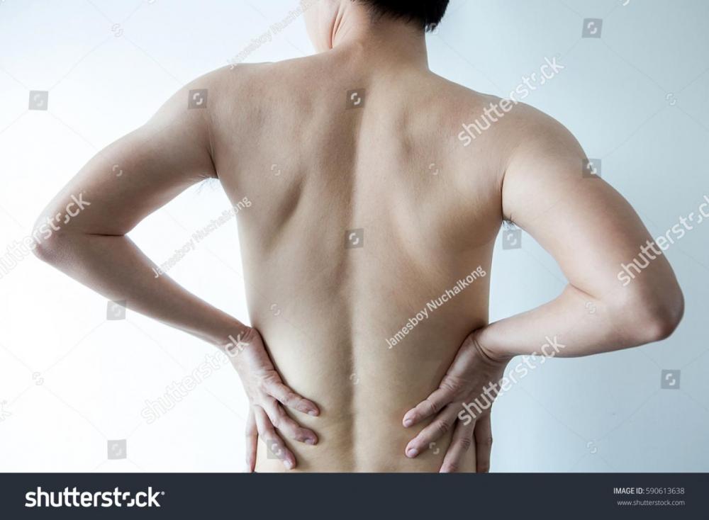 stock-photo-feels-pain-in-the-small-of-the-back-man-with-back-pain-590613638.jpg